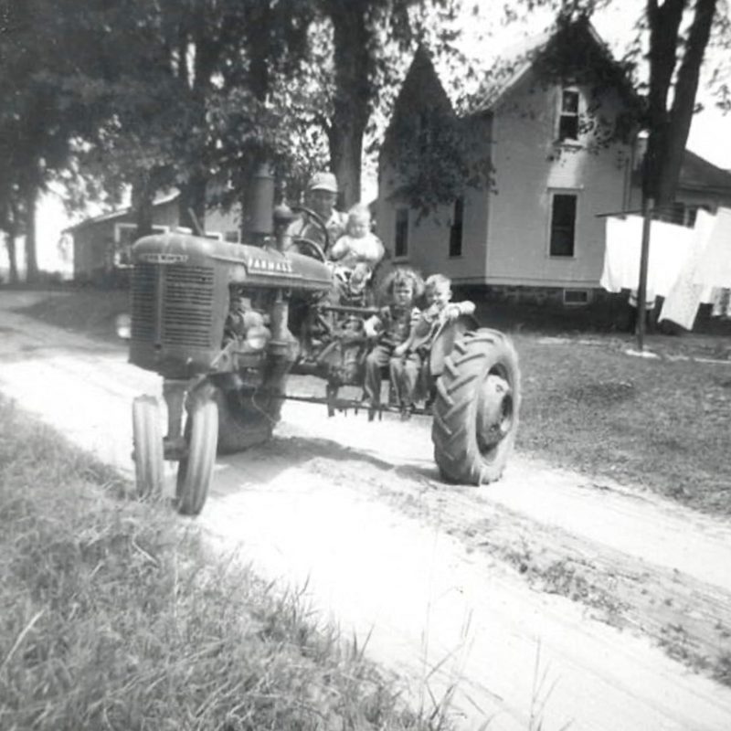 Harold Schroeder sits on tractor on the farm in North Freedom, Wisconsin